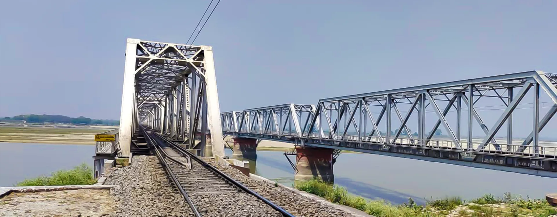 Railway steel bridge crossing a river